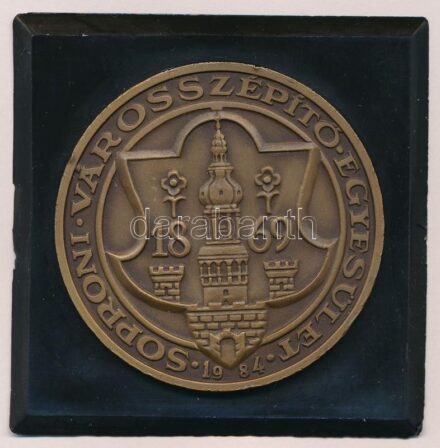 Bogár Lívia (1957-) 1984. '1869 - Soproni Városszépítő Egyesület' Br emlékérem (50mm) műanyag keretben (64x64mm) T:1-