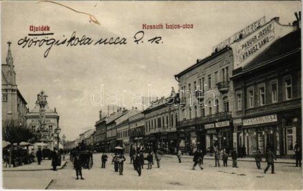 1912 Újvidék, Novi Sad; Kossuth Lajos utca, Divatáruház az Őrangyalhoz, Paquor József, Krausz Samu, Wagner Testvérek üzlete, piac, utcai árusok, Szentháromság szobor / street view, fashion store, shops, market vendors, Holy Trinity