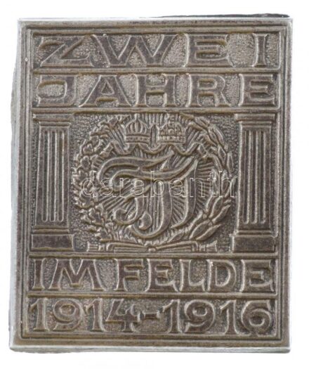 Osztrák-Magyar Monarchia 1914-1916. 'Két év a harcmezőn 1914-1916' Zn sapkajelvény, 'K.u.K. KRIEGSMINISTERIUM KRIEGSFÜRSORGEAMT' gyártói jelzéssel (32x27mm) T:1- Austro-Hungarian Monarchy 1914-1916. 'Zwei Jahre im Felde 1914-1916 (Two