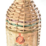 Baronet Kecskeméti Barackpálinka üveg rattan borítással, 1930-1940 körül, m: 33 cm