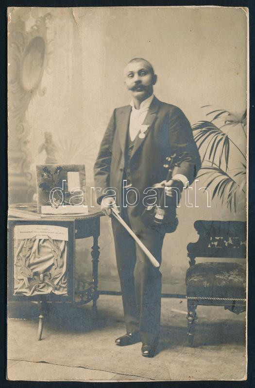 cca 1900 Czutor Béla 'Béla cigány' (1863-1909) cigányprímás, hegedűjével, díjaival ('Ezüst koszorú, Hódmezővásárhely város közönségének ajándéka Czutor Bélának'); keményhátú fotó, körbevágva, 14x9 cm